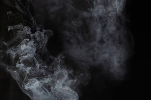 White steam on a black background. Copy space.