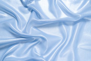 Arka plan olarak mavi parlak inci kumaş. Üst görünüm. 