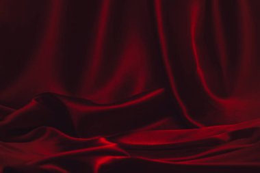 Kırmızı ipek ya da saten lüks kumaş dokusu soyut bir arka plan olarak kullanılabilir. Üst görünüm