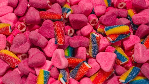 Geassorteerde Smakelijke Gummisnoepjes Bovenaanzicht Roze Gelei Snoepjes Achtergrond — Stockfoto