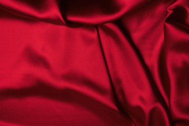 Kırmızı ipek ya da saten lüks kumaş dokusu soyut bir arka plan olarak kullanılabilir. Üst görünüm