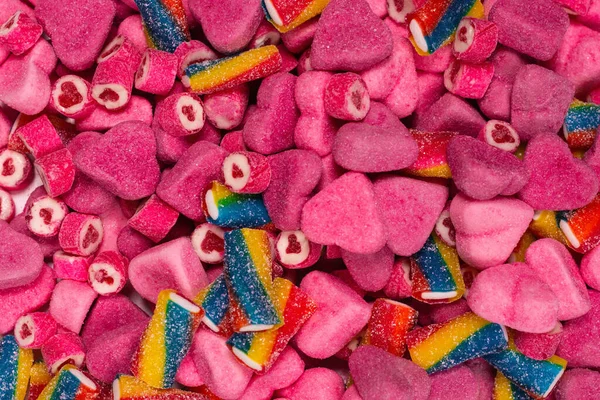 Geassorteerde Smakelijke Gummisnoepjes Bovenaanzicht Roze Gelei Snoepjes Achtergrond — Stockfoto