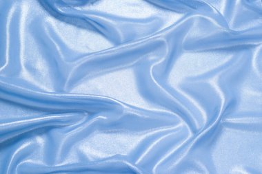 Arka plan olarak mavi parlak inci kumaş. Üst görünüm. 