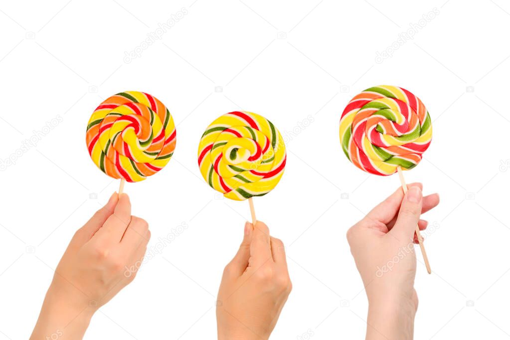 Lollipop in female hand isolated on white  background. Space for text or design.