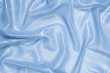 Arka plan olarak mavi parlak inci kumaş. Üst görünüm. 