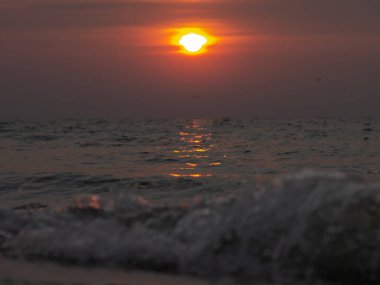 Sahilde güzel bir gün batımı. Yaz günbatımı ve deniz dalgaları