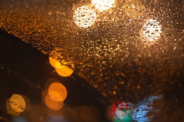 带雨滴和灯光的模糊背景 — 图库照片