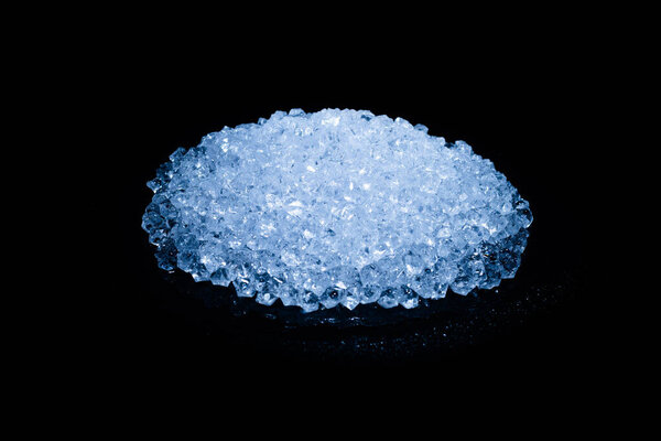 Ice crystal cubes on a black background, space for text or design.