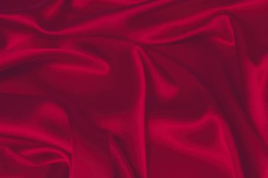 Kırmızı ipek ya da saten lüks kumaş dokusu soyut bir arka plan olarak kullanılabilir. Üst görünüm.