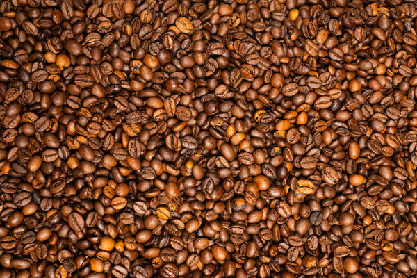 Coffee beans on a white background. Top view. Coffee beans texture.