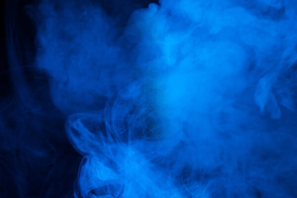 Blue steam on a black background. Copy space.