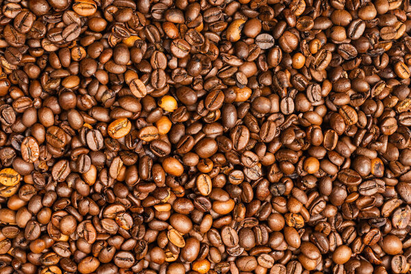 Coffee beans on a white background. Top view. Coffee beans texture.