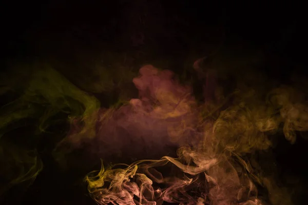 stock image Yellow and pink steam on a black background. Copy space.