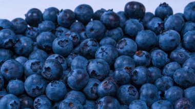 Blueberries in a plastic container isolated on a white background. 