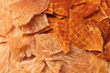 A group of tasty beer snacks. Dehydrated chicken meat slices. 