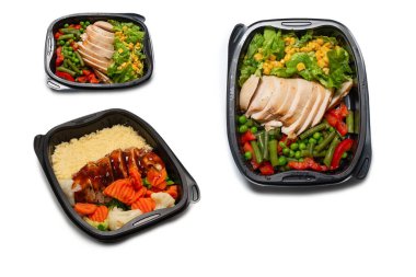 Konteynırda yemek hazır. Teriyaki soslu haşlanmış tavuk, haşlanmış havuç, lahana ve yulaf lapası. Beyaz bir arkaplanda izole edilmiş. 