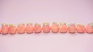 Orange marshmallow candy isolated on a white background. 