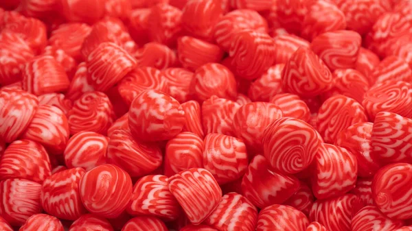 Red round tasty gummy candies as a background. Top view.