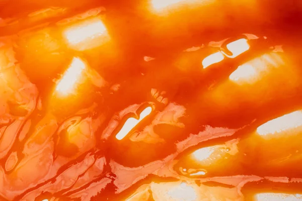 Tasty red sauce splashes as a background.