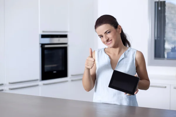 Woman showing a digital tablet and hand gesturing okay sign — Stock Photo, Image