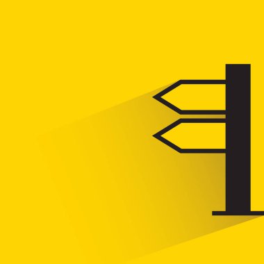 street signpost and signage with shadow on yellow background