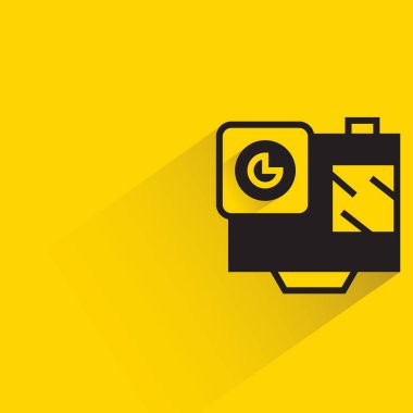 action camera with shadow on yellow background