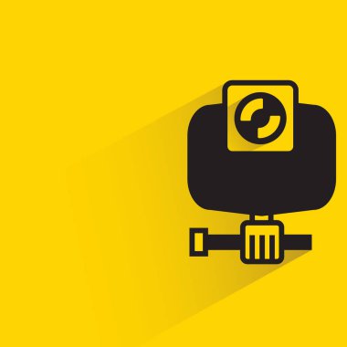 action camera with shadow on yellow background