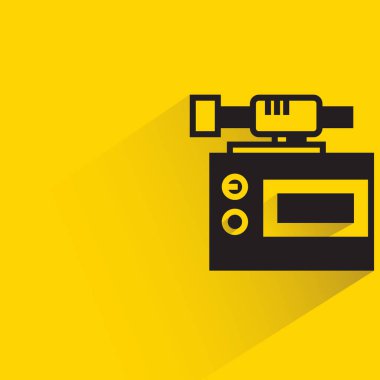 action camera with shadow on yellow background