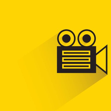 video camera with shadow on yellow background