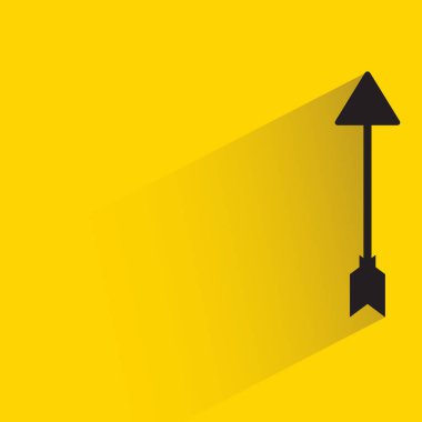 arrow with shadow on yellow background