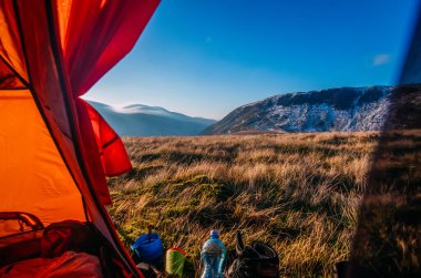 mountain view from orange tent at sunrise