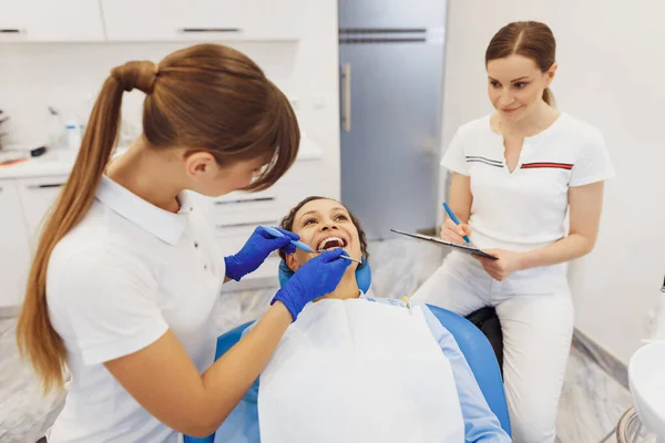 Νεαρός Οδοντίατρος Έλεγχο Των Δοντιών Γυναίκα Στην Οδοντιατρική Καρέκλα Ενώ — Φωτογραφία Αρχείου