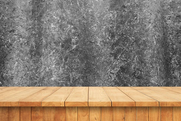 Empty wooden table and wall