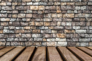 Empty wooden table and old stone wall background