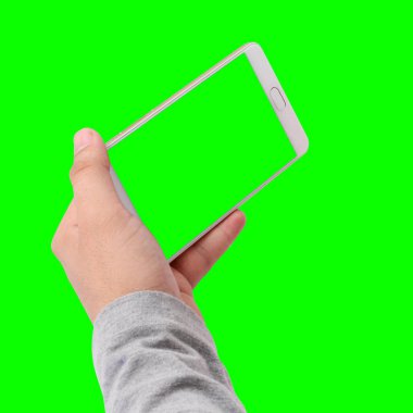 Hand holding phone with green background