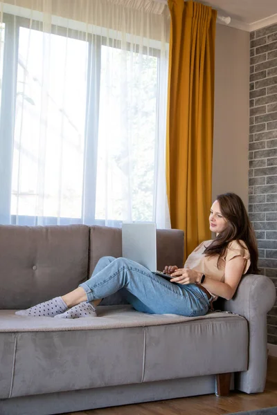 Comfortable work from home. A young woman is working remotely with a laptop. — Stock Photo, Image