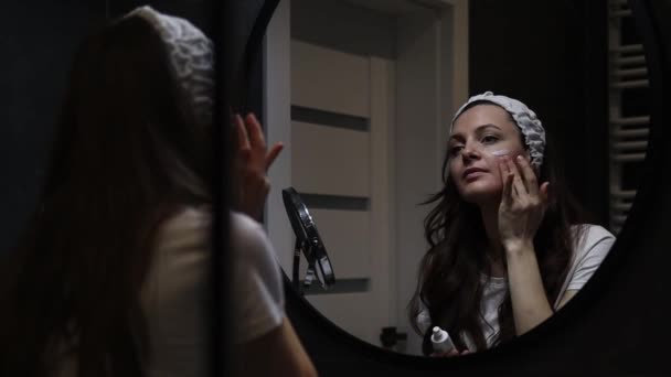Poziome wideo młodej kobiety w opasce z kremem nawilżającym do twarzy — Wideo stockowe