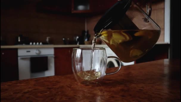 Person Making Tea Pouring Out Glass Cup Transparent Teapot Home — Vídeos de Stock