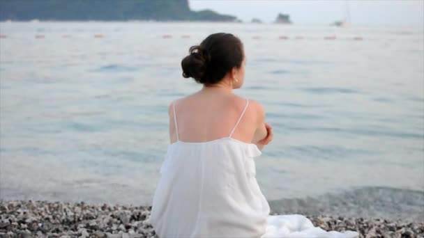 Young Woman White Dress Sitting Alone Beach Looking Sea Twilling — Video