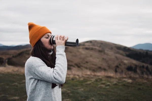 Young Woman Orange Beanie Hat Drinking Tea Thermos Outdoors Front — Stock Photo, Image