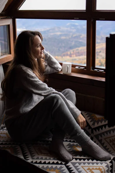 Young Woman Sitting Cozy House Drinking Tea Looking Out Window — Stock Photo, Image