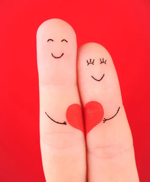 Aile kavramı - erkek ve kadın kırmızı kalp üzerinde tutun, boyalı — Stok fotoğraf