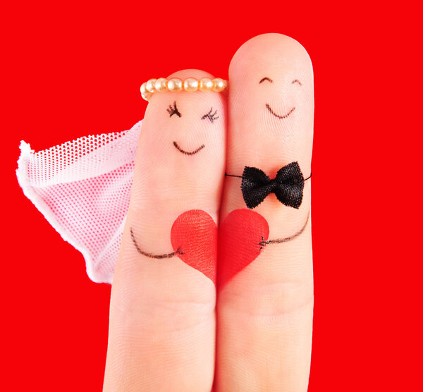 wedding concept, newlyweds with heart against red background, p