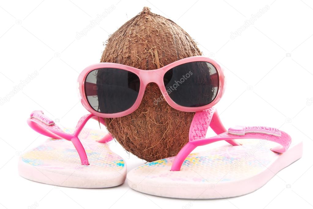coconut concept for travel agency with sunglasses and beachwear