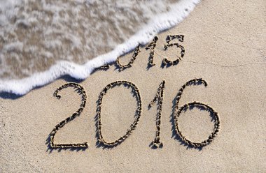 Happy New Year 2016 replace 2015 concept on the sea beach clipart