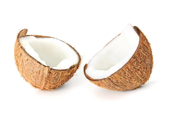 Two coconut halfs with milk isolated on white — Stock Photo, Image