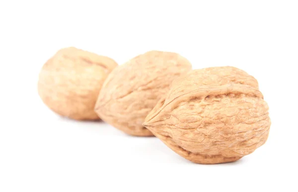 Три грецкие орехи изолированы на белом — стоковое фото
