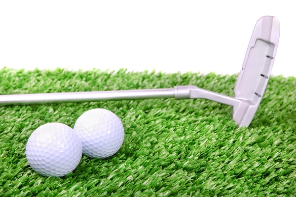 Two golf balls and club on green grass — Stock Photo, Image