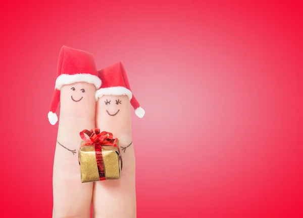 Fingergesichter in Weihnachtsmannhüten — Stockfoto