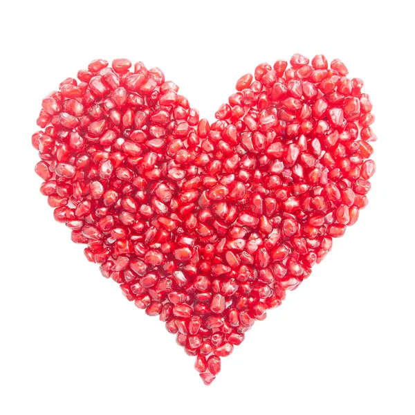 Heart-shaped pomegranate seeds isolated on white — Stock Photo, Image